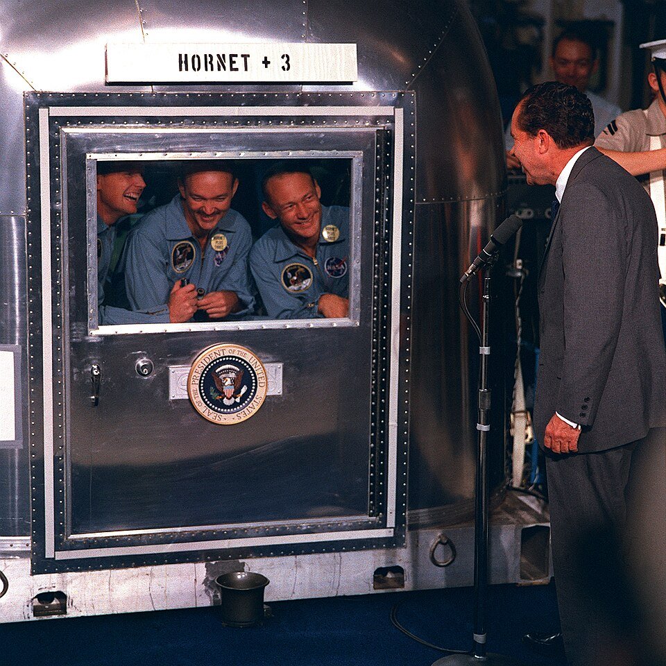 Apollo 11 astronauts in the quarantine trailer after returning from the Moon, greeted by the US President
