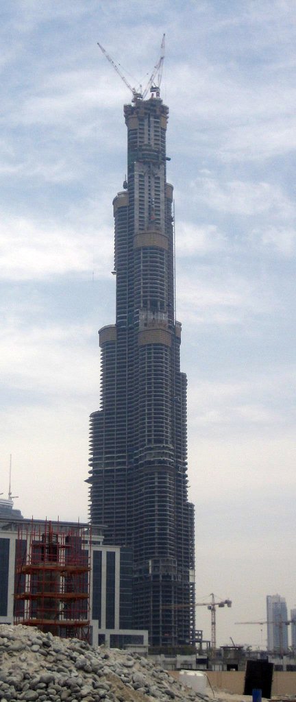 Burj Khalifa under construction in Dubai, with tower crane visible at the summit