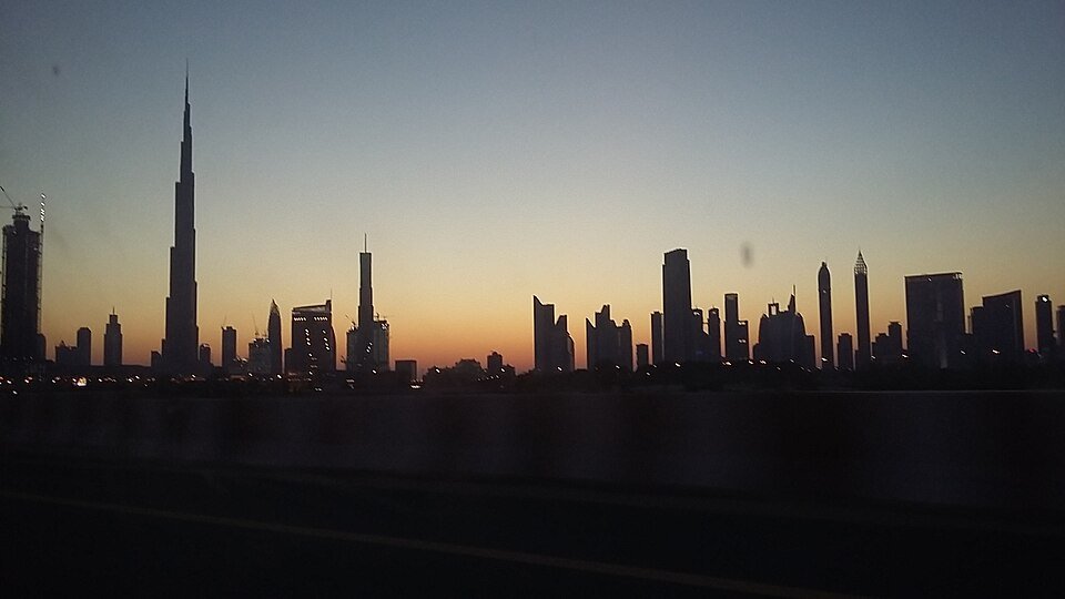 Dubai skyline at dusk with Burj Khalifa silhouetted above the surrounding towers