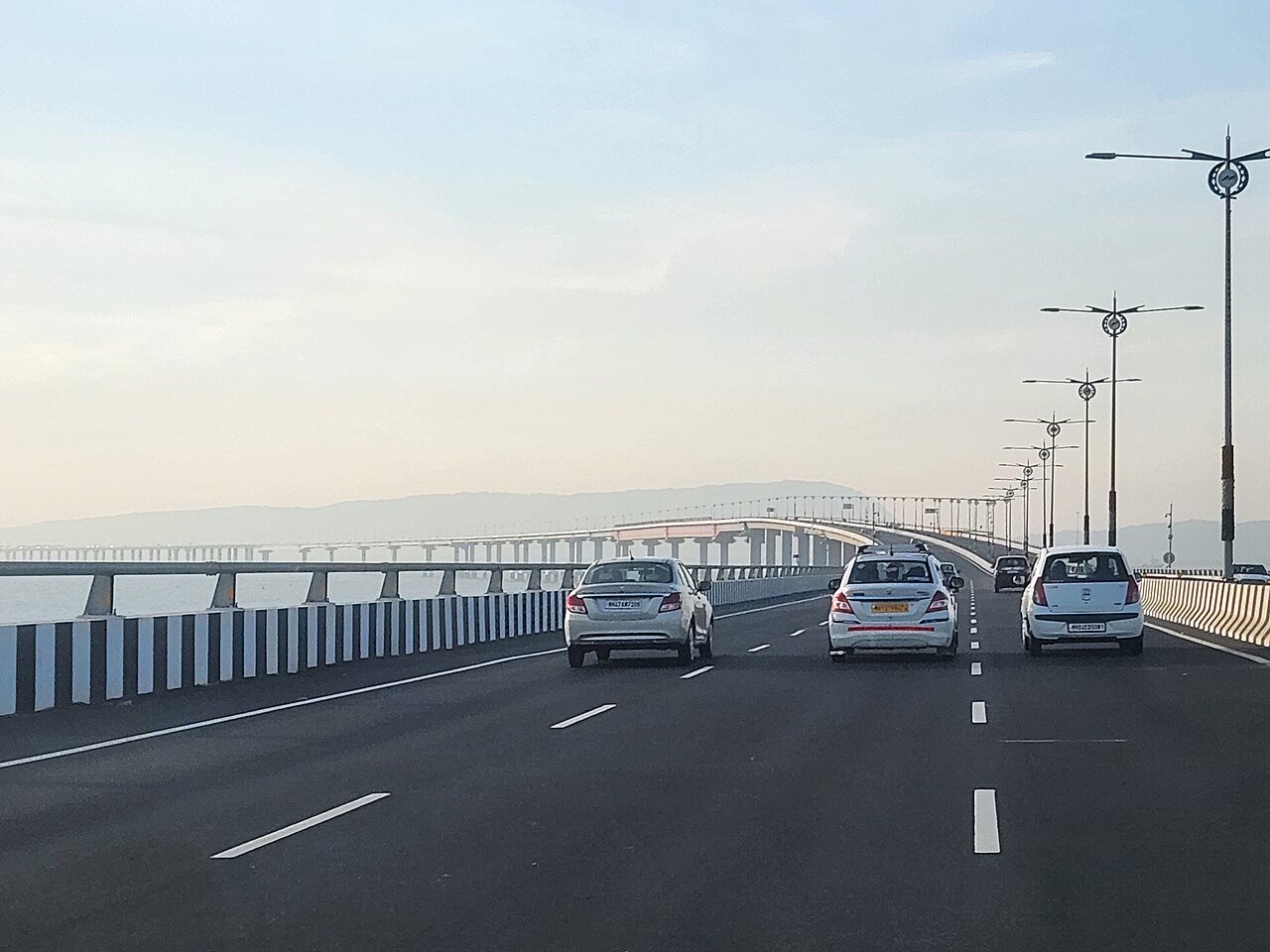 Cars driving on the six-lane Atal Setu deck over Mumbai Harbour