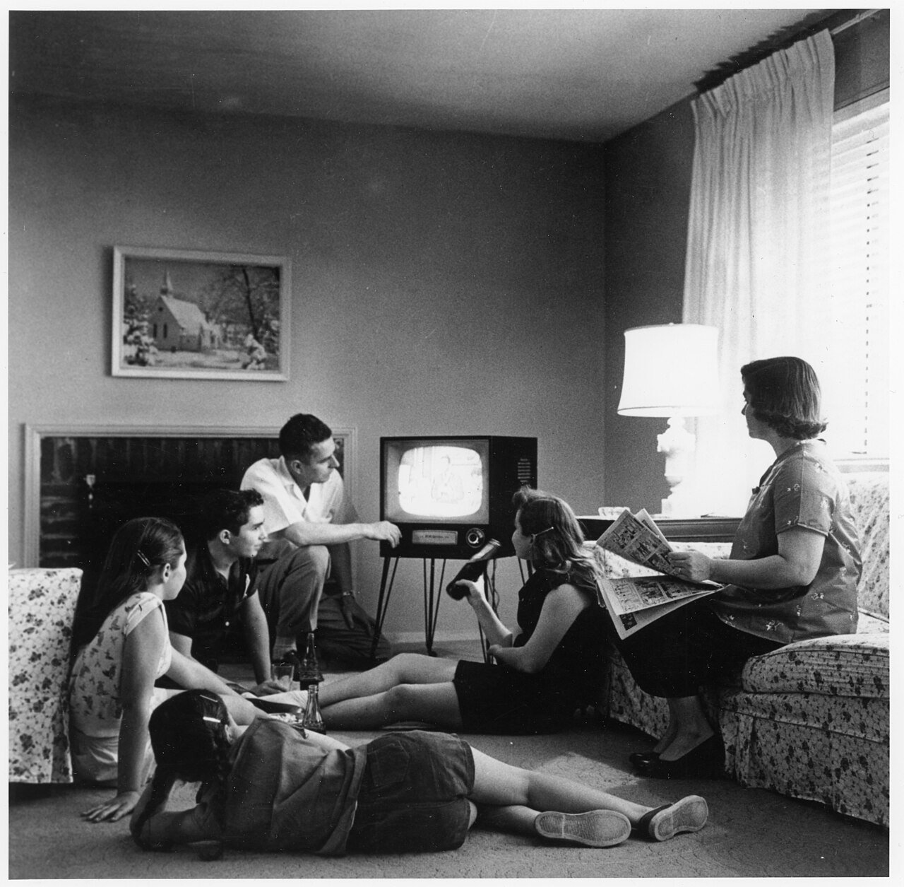 An American family watching television in their living room around 1958