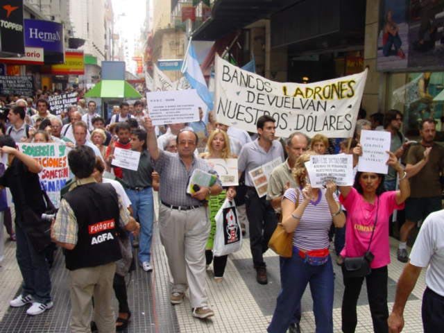 Demonstrators in Buenos Aires carrying banners demanding banks return their dollars during the corralito