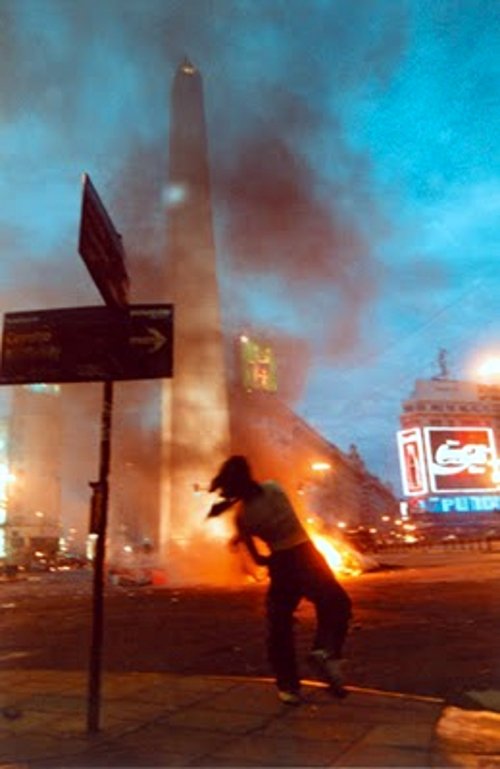 A protester and burning debris near the Obelisco in Buenos Aires on the night of 20 December 2001