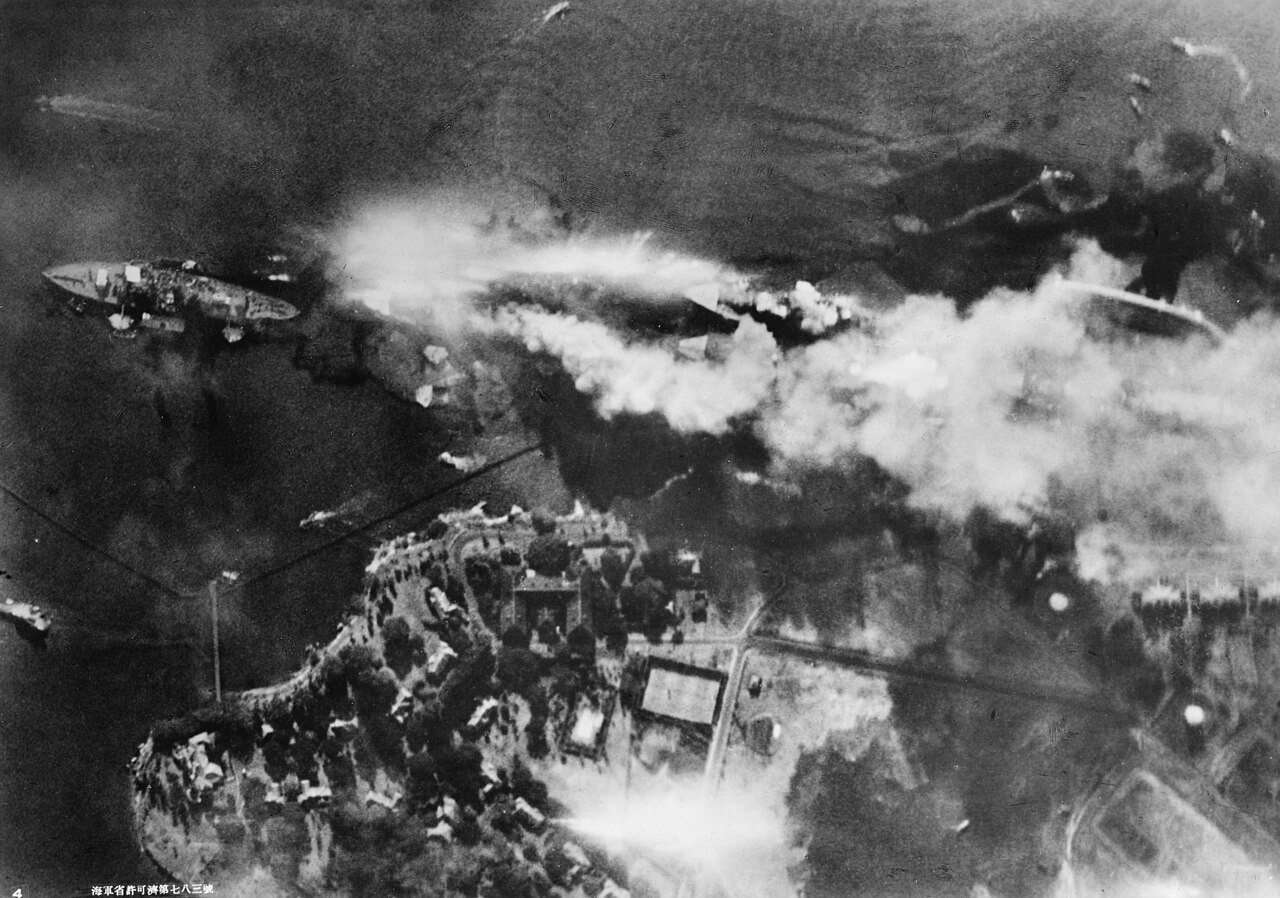 Battleship Row beside Ford Island, photographed from a Japanese aircraft soon after the USS Arizona was hit