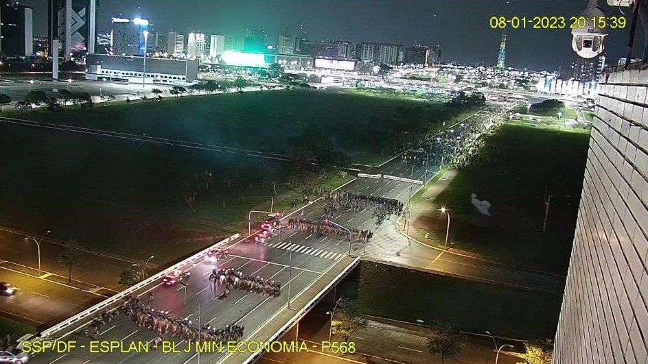 Night-time security camera view of police lines on the road near the Three Powers Plaza in Brasilia on 8 January 2023