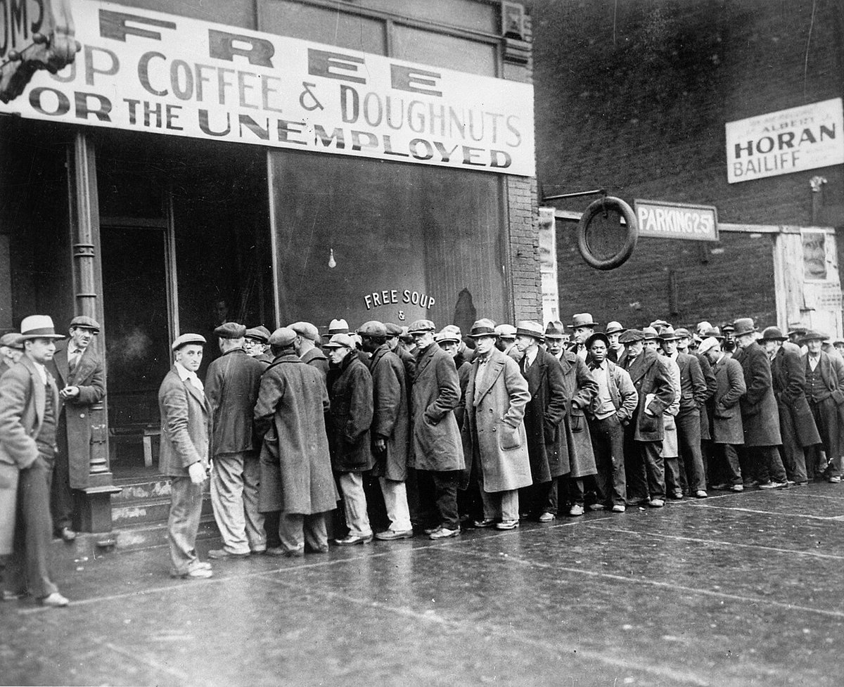 Unemployed men queue outside a free soup kitchen in Chicago, February 1931