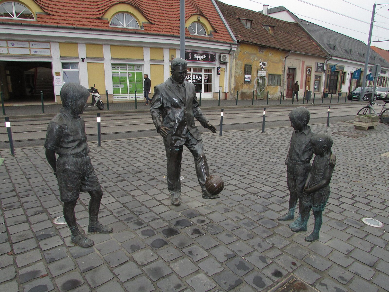 Statue of Ferenc Puskás playing with children in Óbuda