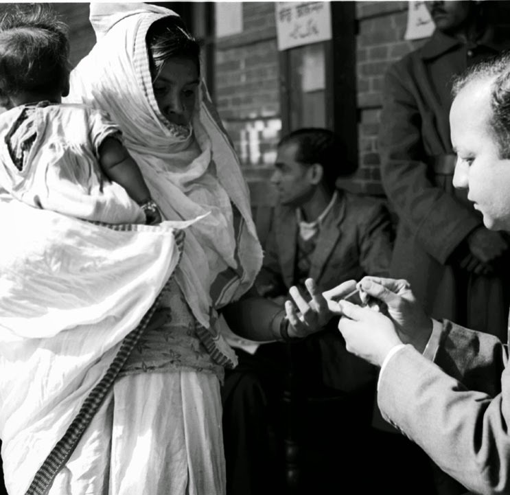 A polling officer marks a voter’s finger with indelible ink in Delhi on 14 January 1952
