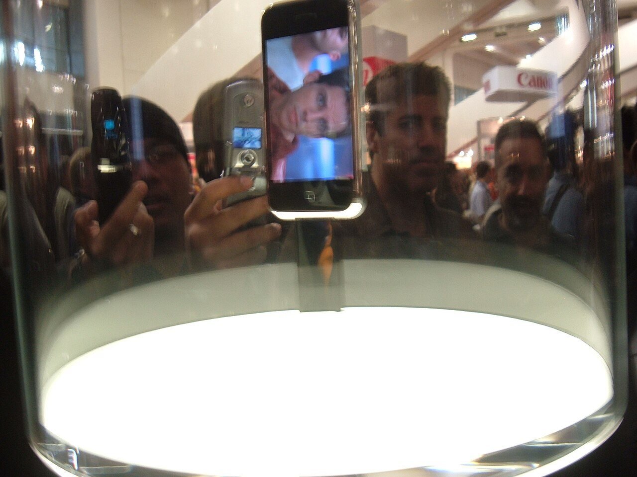 The first iPhone under a glass dome on the Macworld show floor, the afternoon it was unveiled