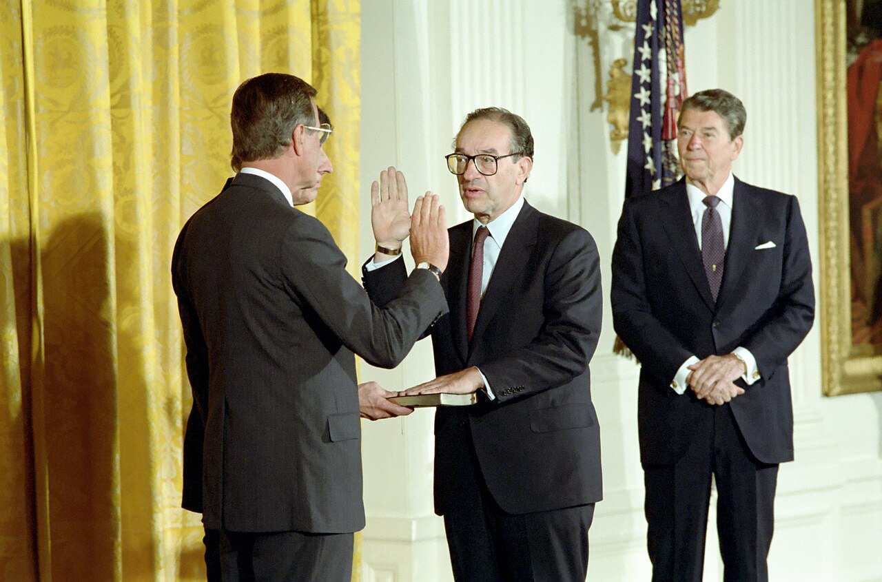 Alan Greenspan takes the oath as Federal Reserve chairman in the East Room of the White House, with President Ronald Reagan, on 11 August 1987