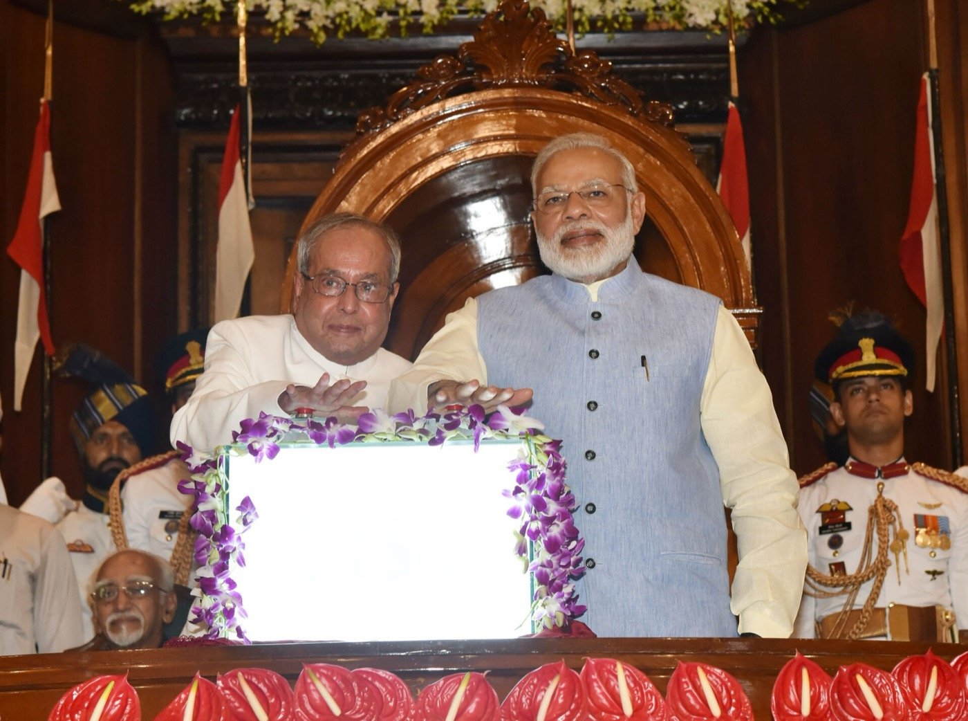 President Pranab Mukherjee and Prime Minister Narendra Modi press the buzzer to launch GST in the Central Hall of Parliament at midnight on 30 June–1 July 2017