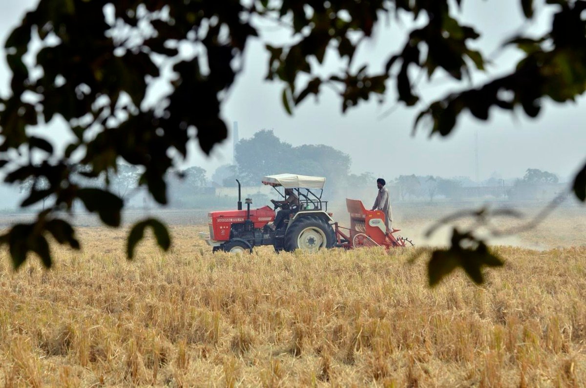 A tractor-drawn Happy Seeder sowing wheat directly into rice stubble in Punjab, November 2011, so the straw does not have to be burned