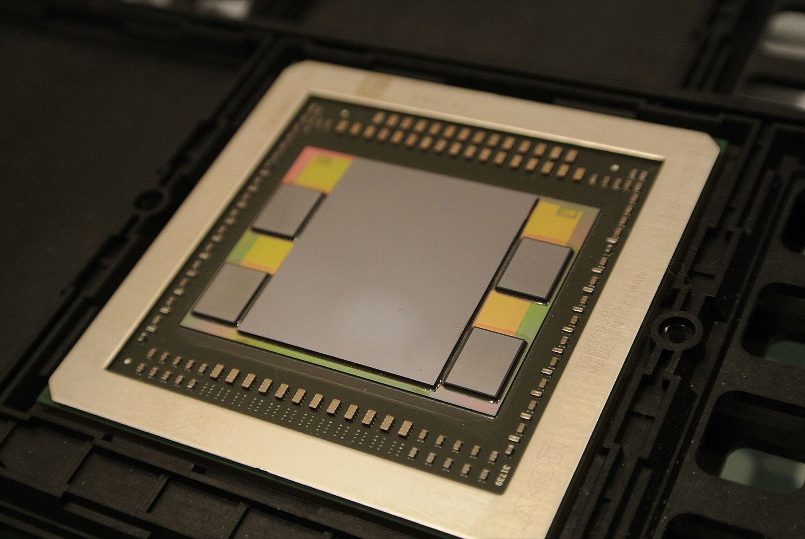 An AMD Fiji GPU package from 2015 with four HBM memory stacks beside the compute die on a silicon interposer