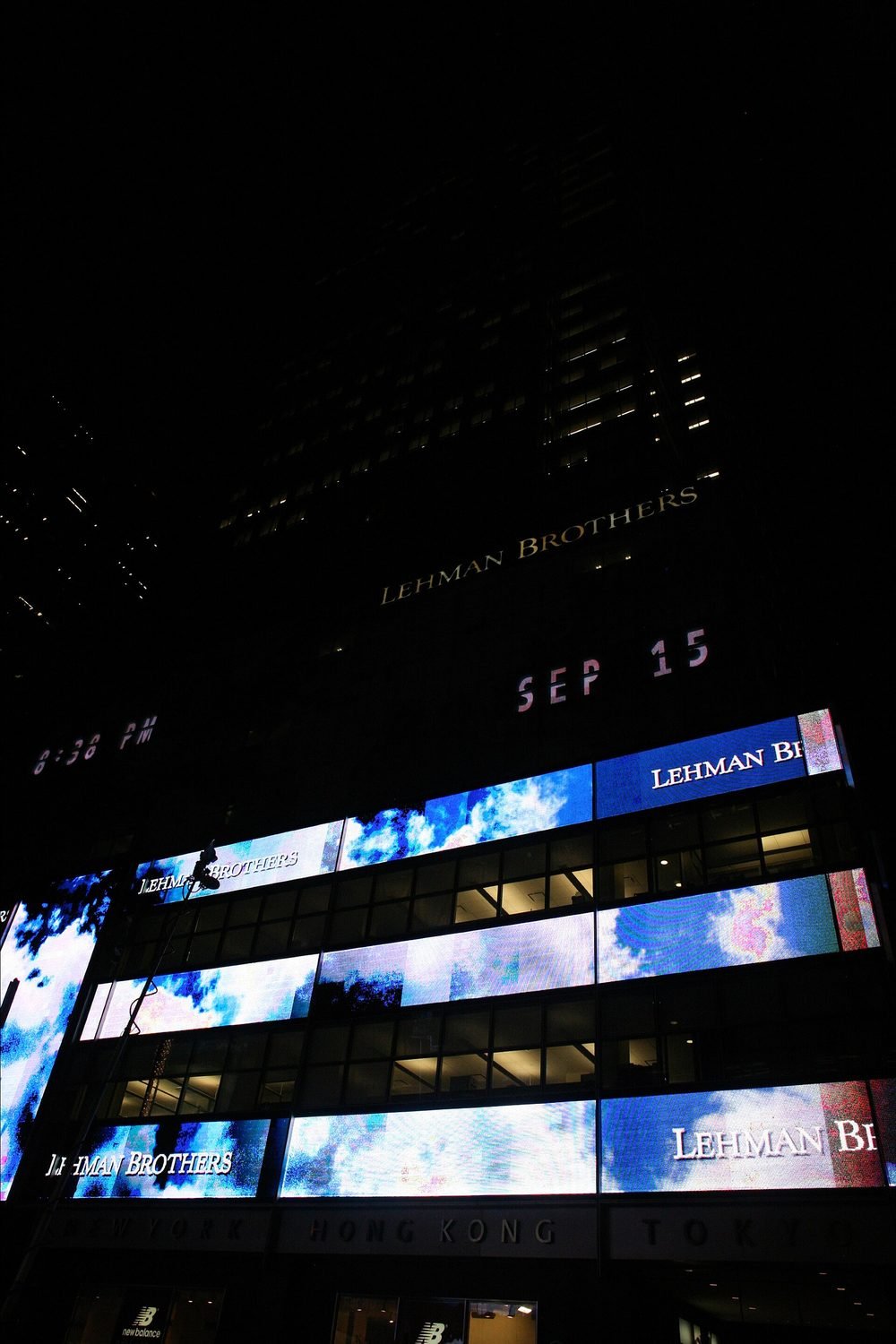 The Lehman Brothers headquarters display shows the date, SEP 15, on the night of the bankruptcy