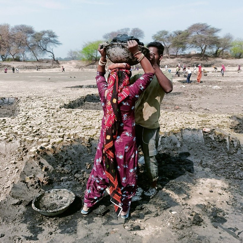 MGNREGA workers carrying silt out of a dry village pond at Asir in Sirsa district, Haryana