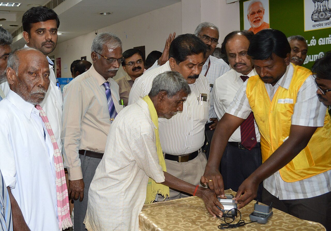 A villager draws cash through a micro-ATM at a post-demonetisation digital banking workshop in Theni, Tamil Nadu, December 2016