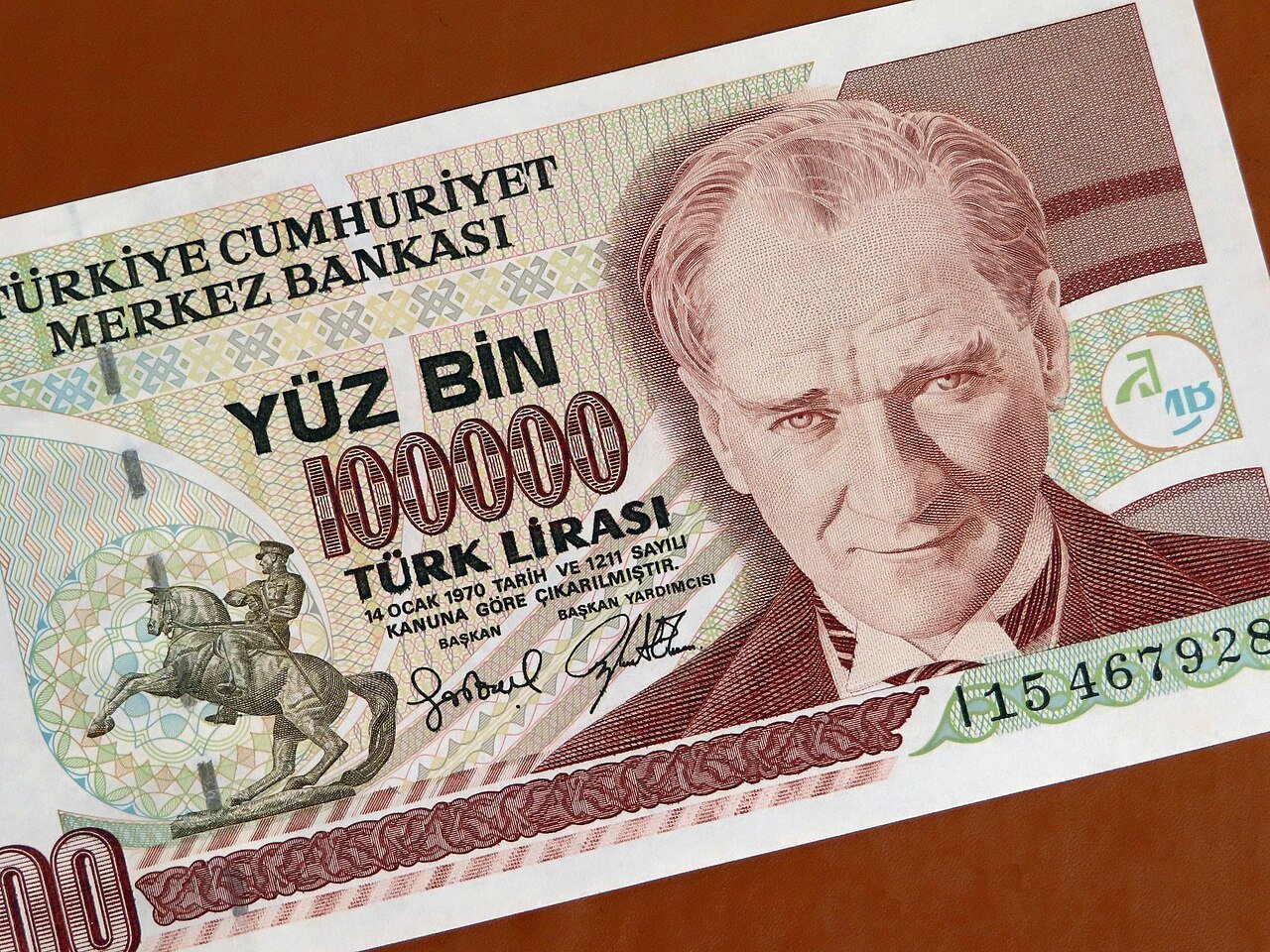 A 100,000 Turkish lira banknote with a portrait of Atatürk and an equestrian statue
