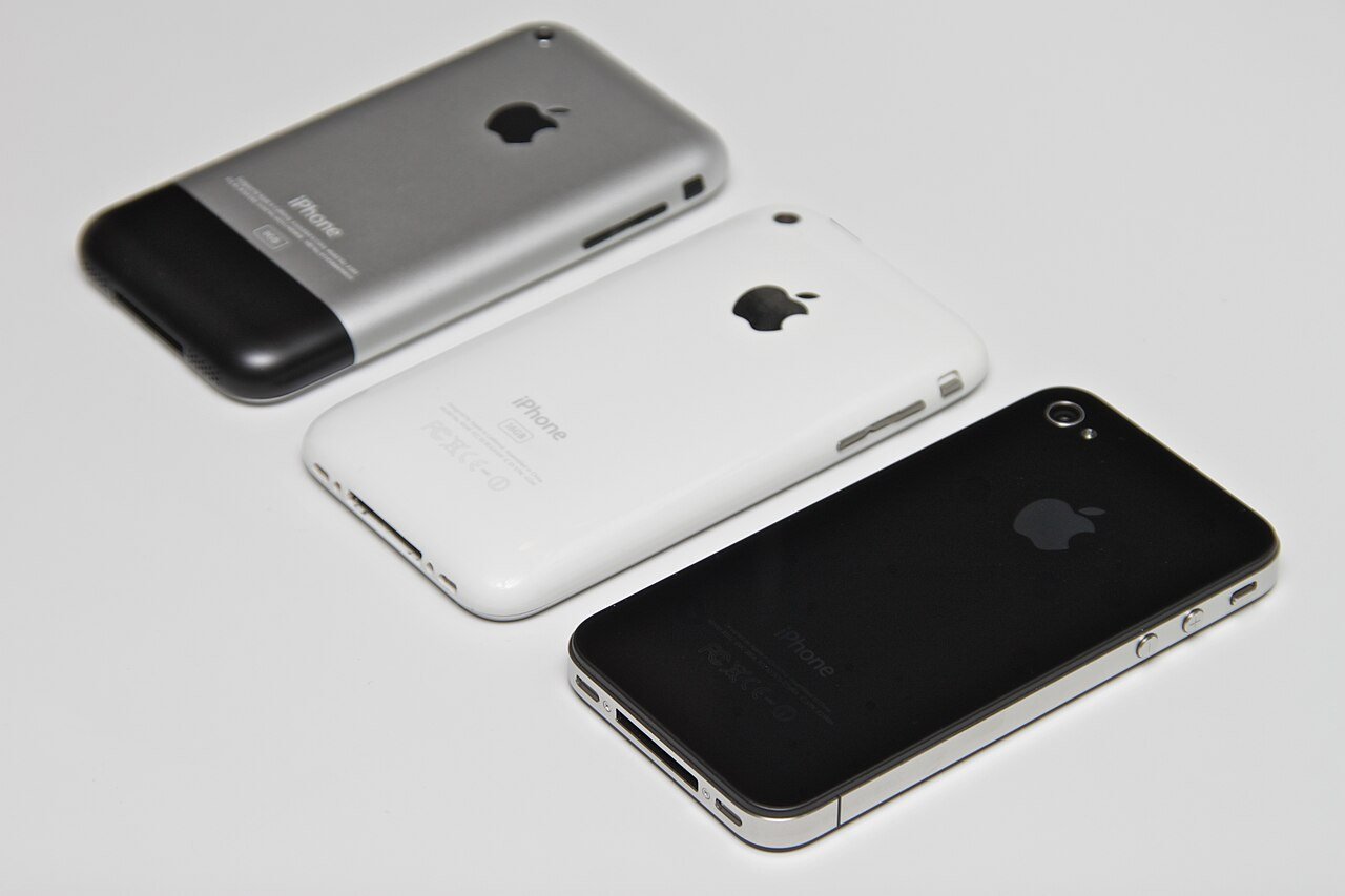 Three generations: the aluminium original iPhone (2007), the plastic iPhone 3G (2008) and the glass iPhone 4 (2010)