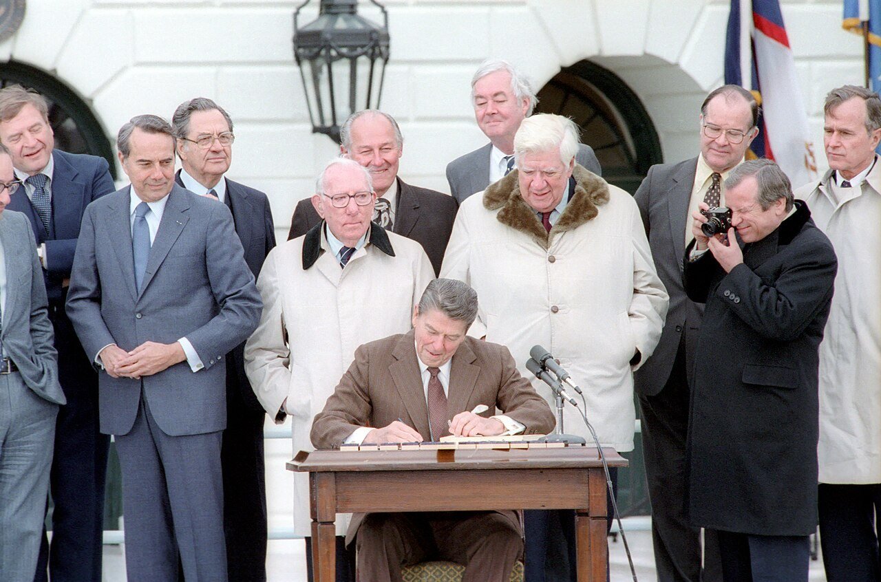 Ronald Reagan signs the Social Security Amendments of 1983 on the White House South Lawn on 20 April 1983