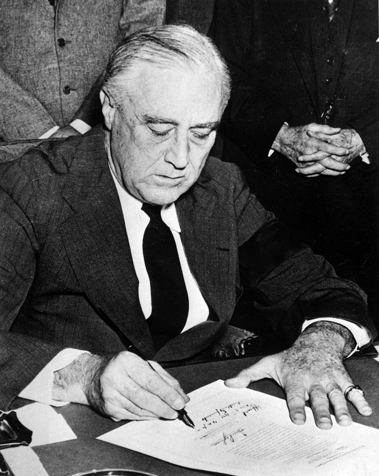 President Franklin D. Roosevelt signs the declaration of war against Japan on 8 December 1941