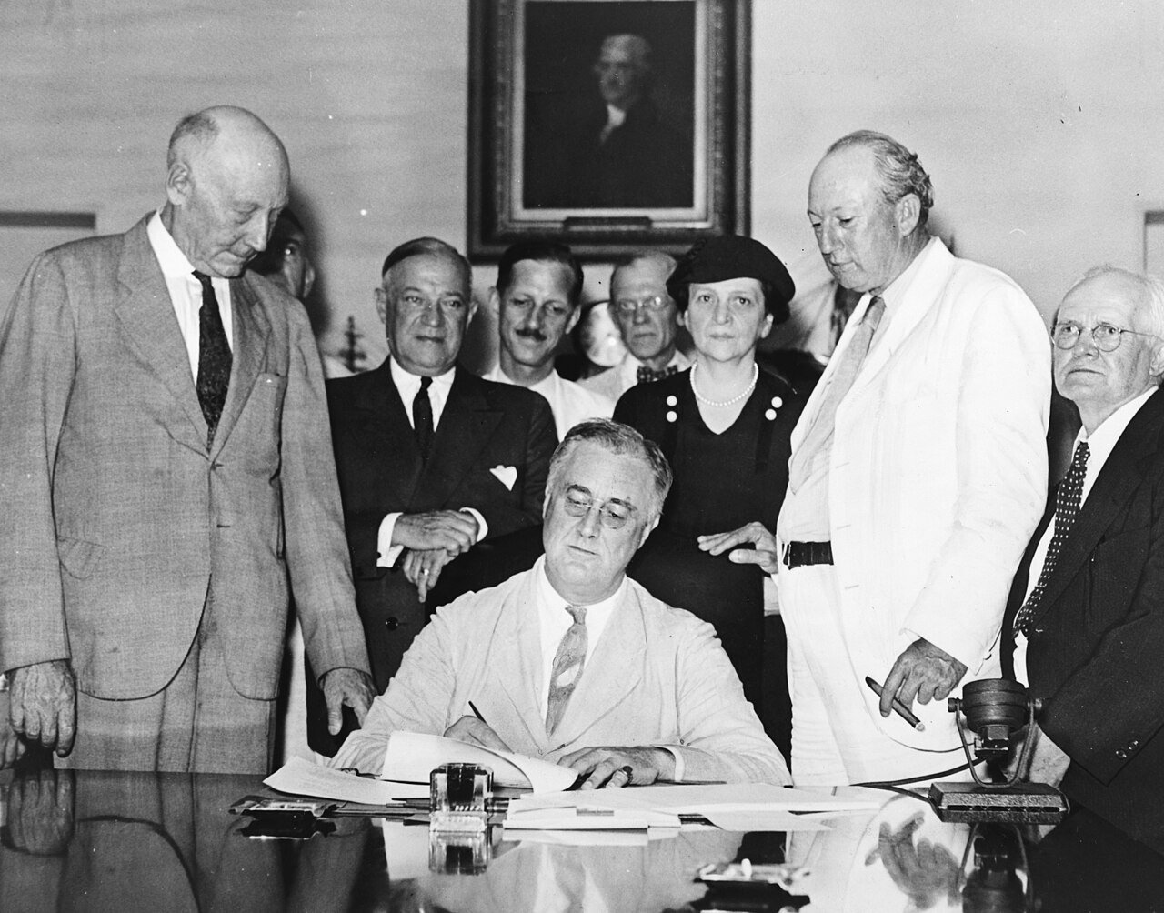 President Franklin D. Roosevelt signs the Social Security Act in Washington on 14 August 1935