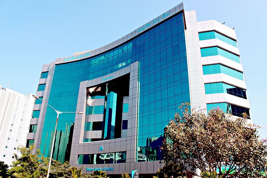 The curved blue-green glass facade of the State Bank of India Local Head Office building in Mumbai