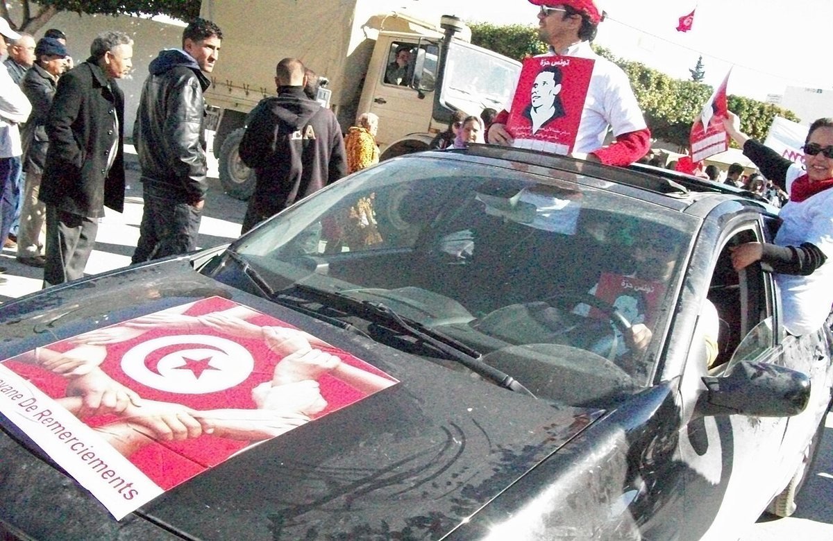 Sidi Bouzid in 2011, with a Tunisian flag and a poster of Mohamed Bouazizi