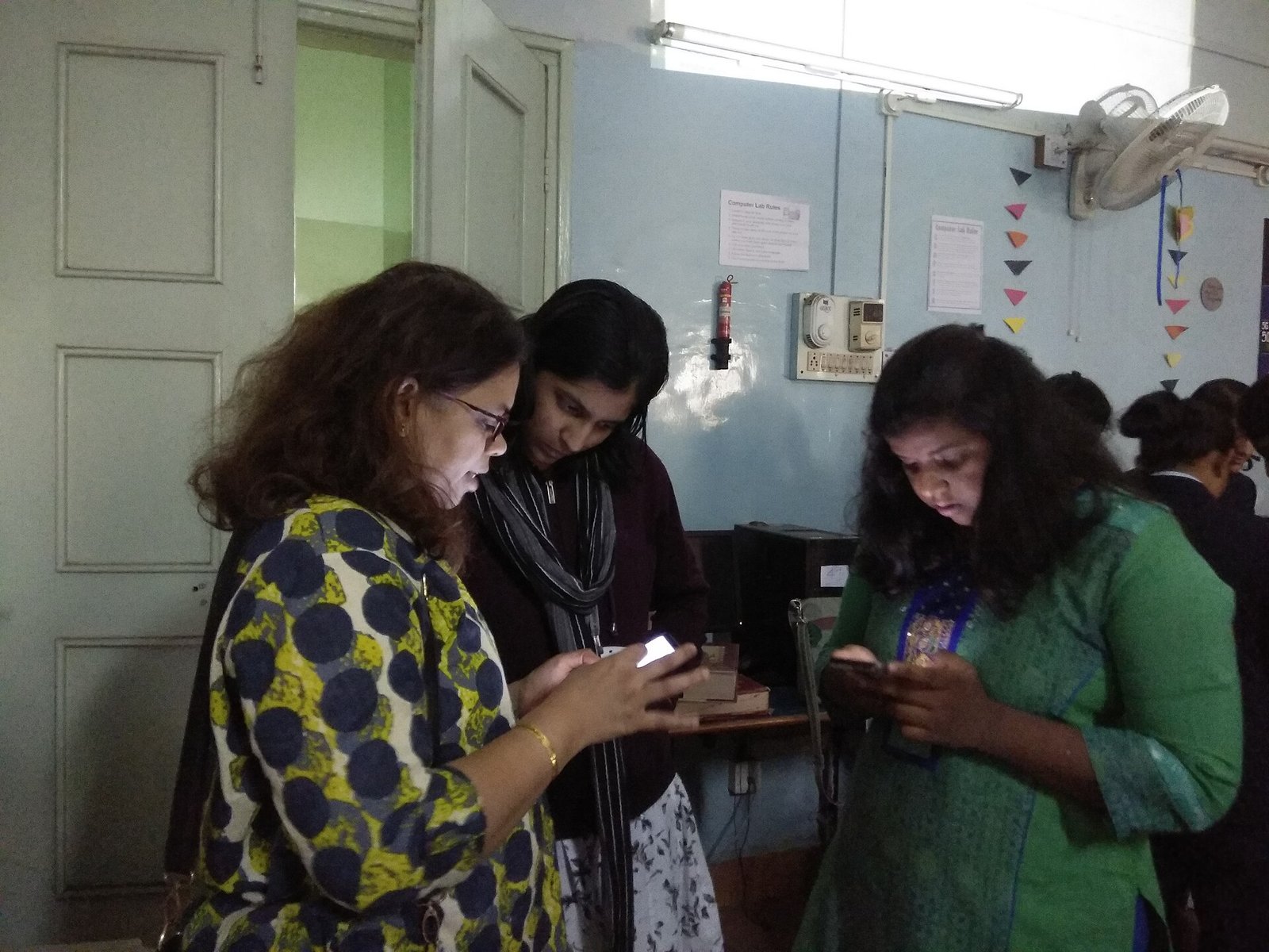 Participants work on smartphones at a training workshop in Maharashtra