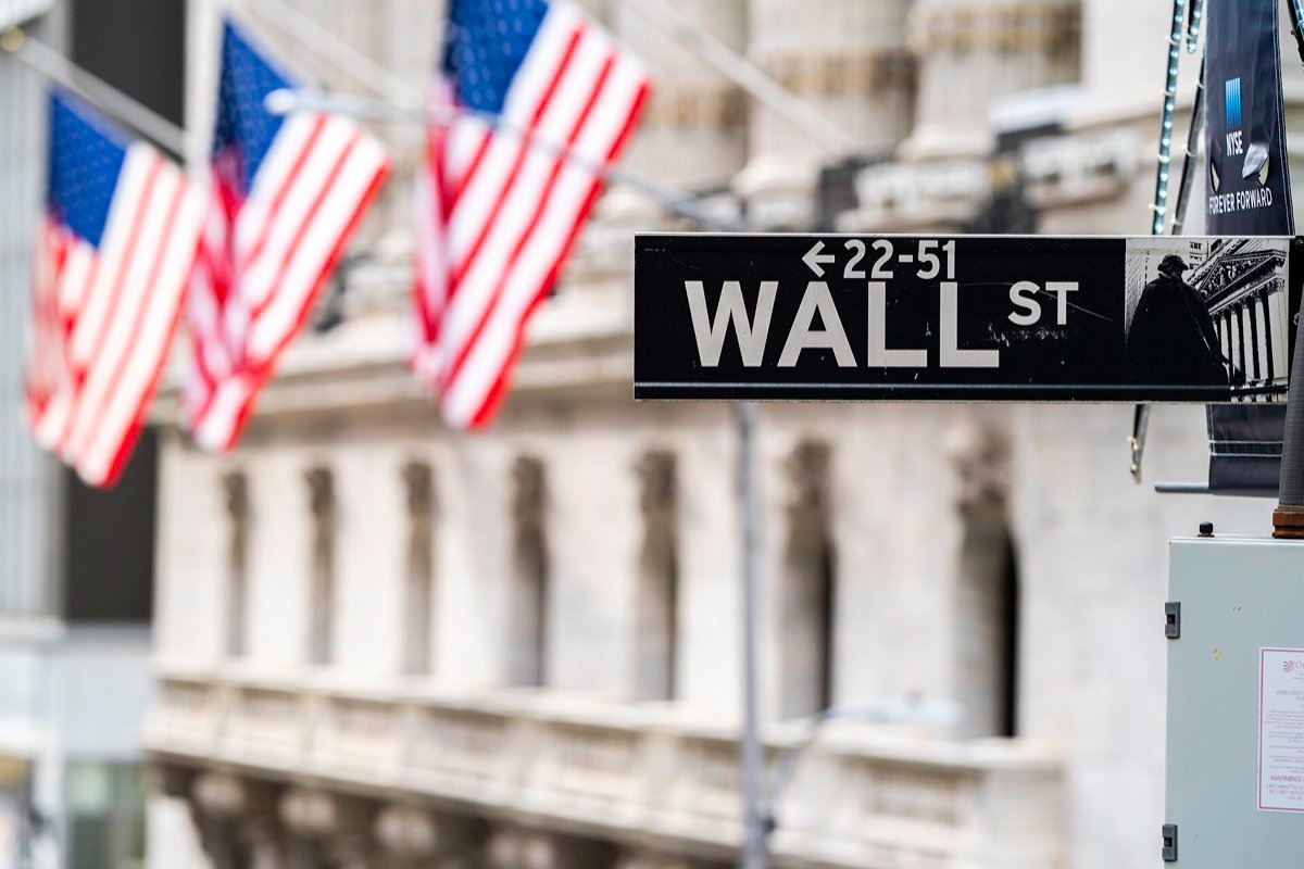 The Wall Street sign outside the New York Stock Exchange in January 2021, the month a heavily shorted video-game retailer became the most-watched stock in the world